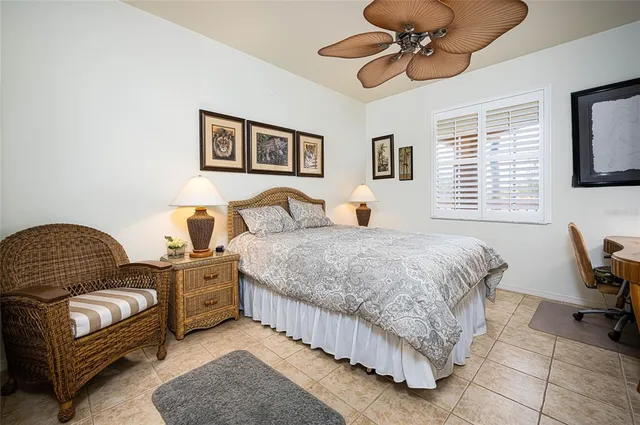 a bedroom with a bed chair and window