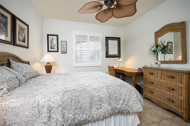 a bedroom with a bed and dresser with mirror