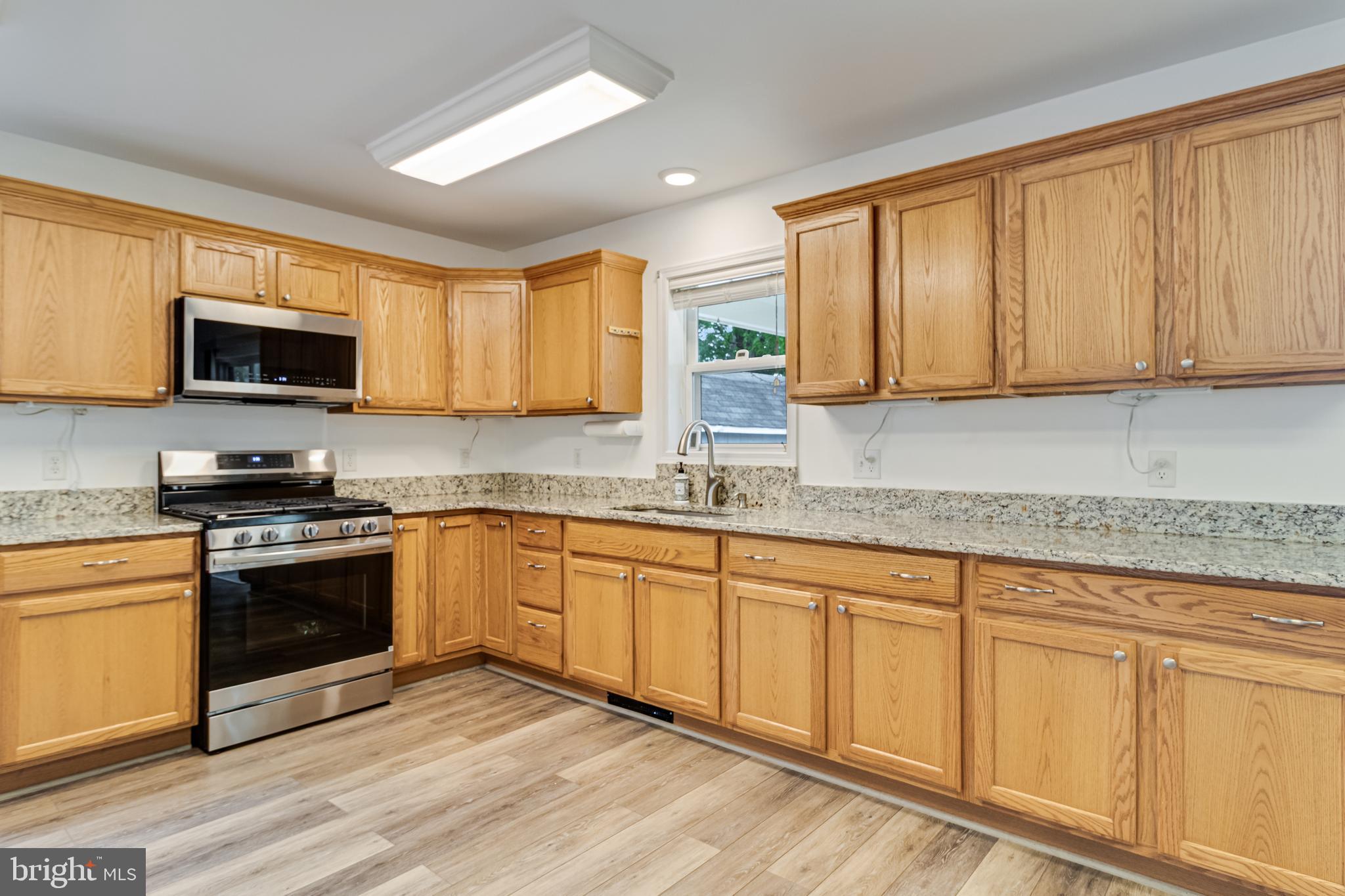 12015 Woodbury Road Nanjemoy, MD 20662 - Photo 19 of 53 a kitchen with stainless steel appliances granite countertop a stove a sink and a microwave