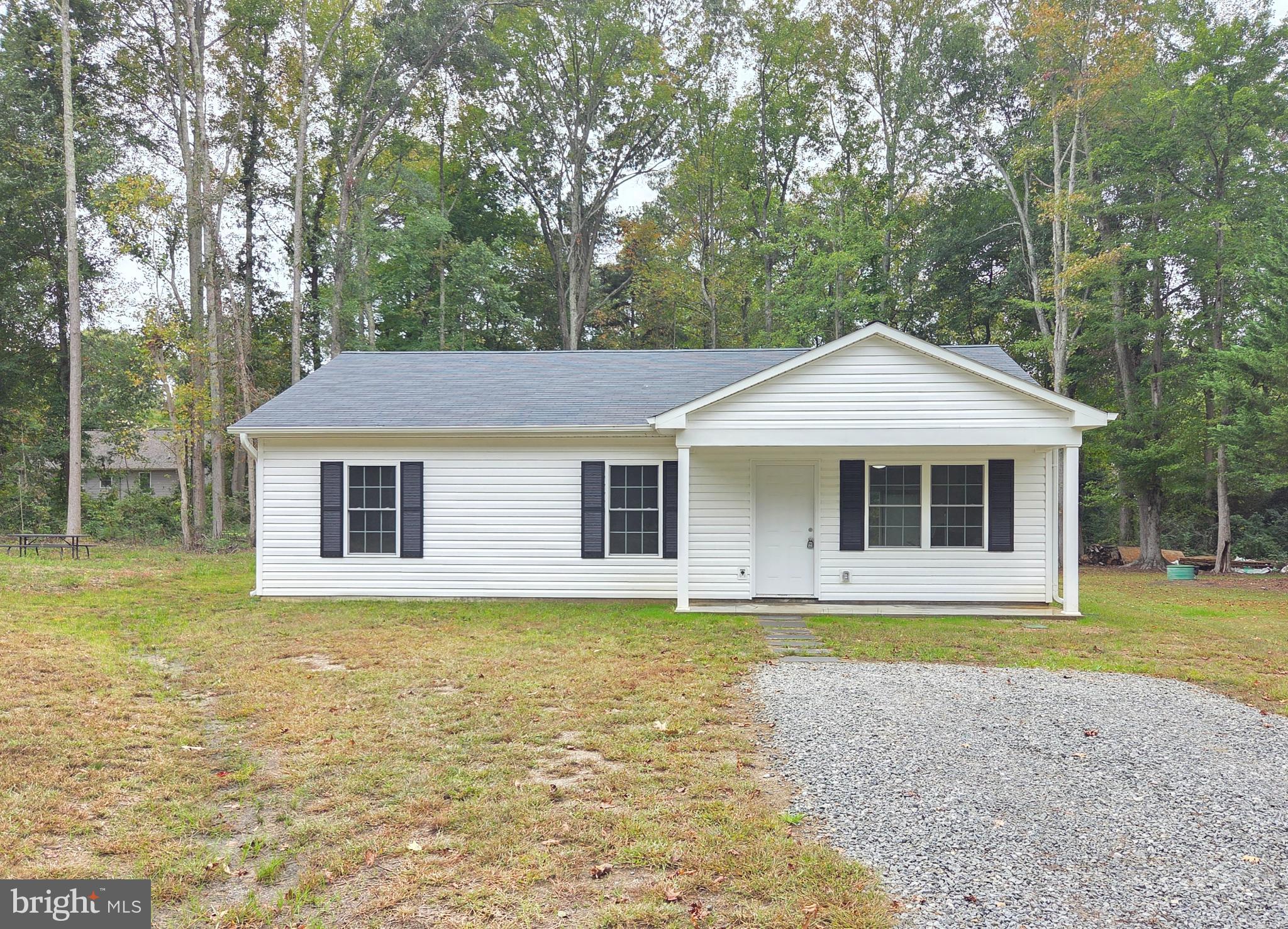 227 Forest Grove Road Colonial Beach, VA 22443 - Photo 2 of 22 a front view of a house with garden
