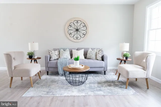 a living room with furniture a rug and a window