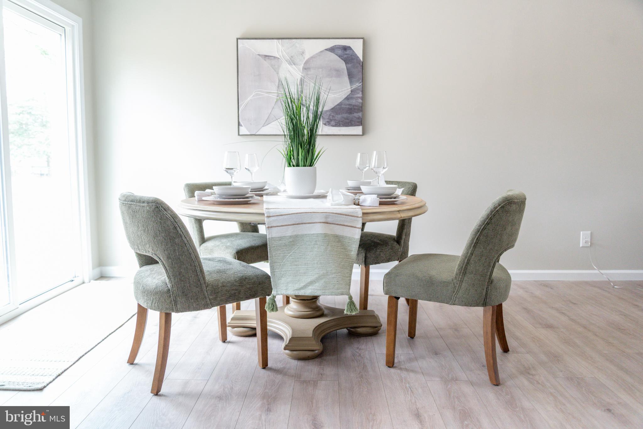 227 Forest Grove Road Colonial Beach, VA 22443 - Photo 6 of 22 a view of a dining room with furniture and wooden floor