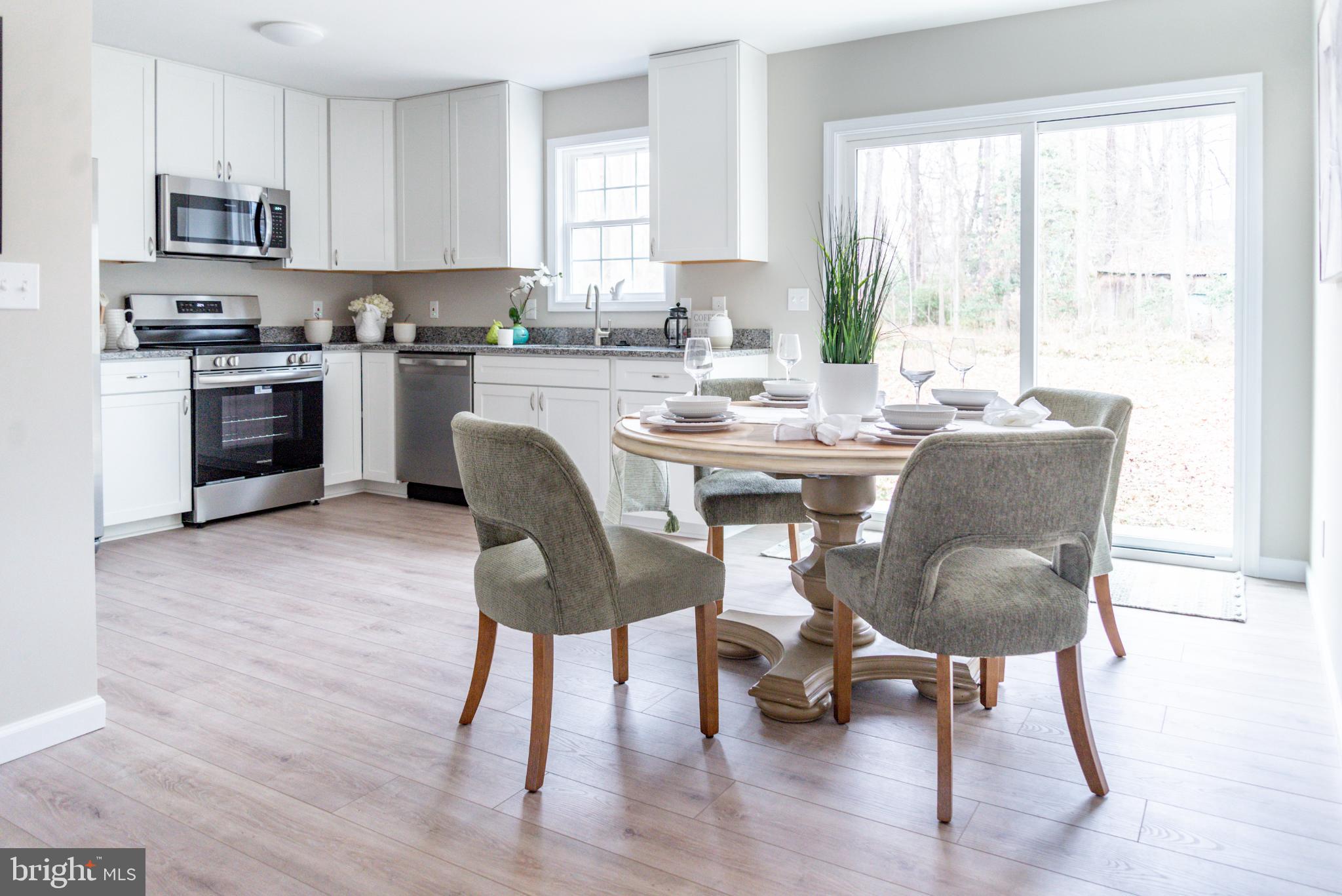 227 Forest Grove Road Colonial Beach, VA 22443 - Photo 22 of 22 a view of kitchen with dining table and chairs