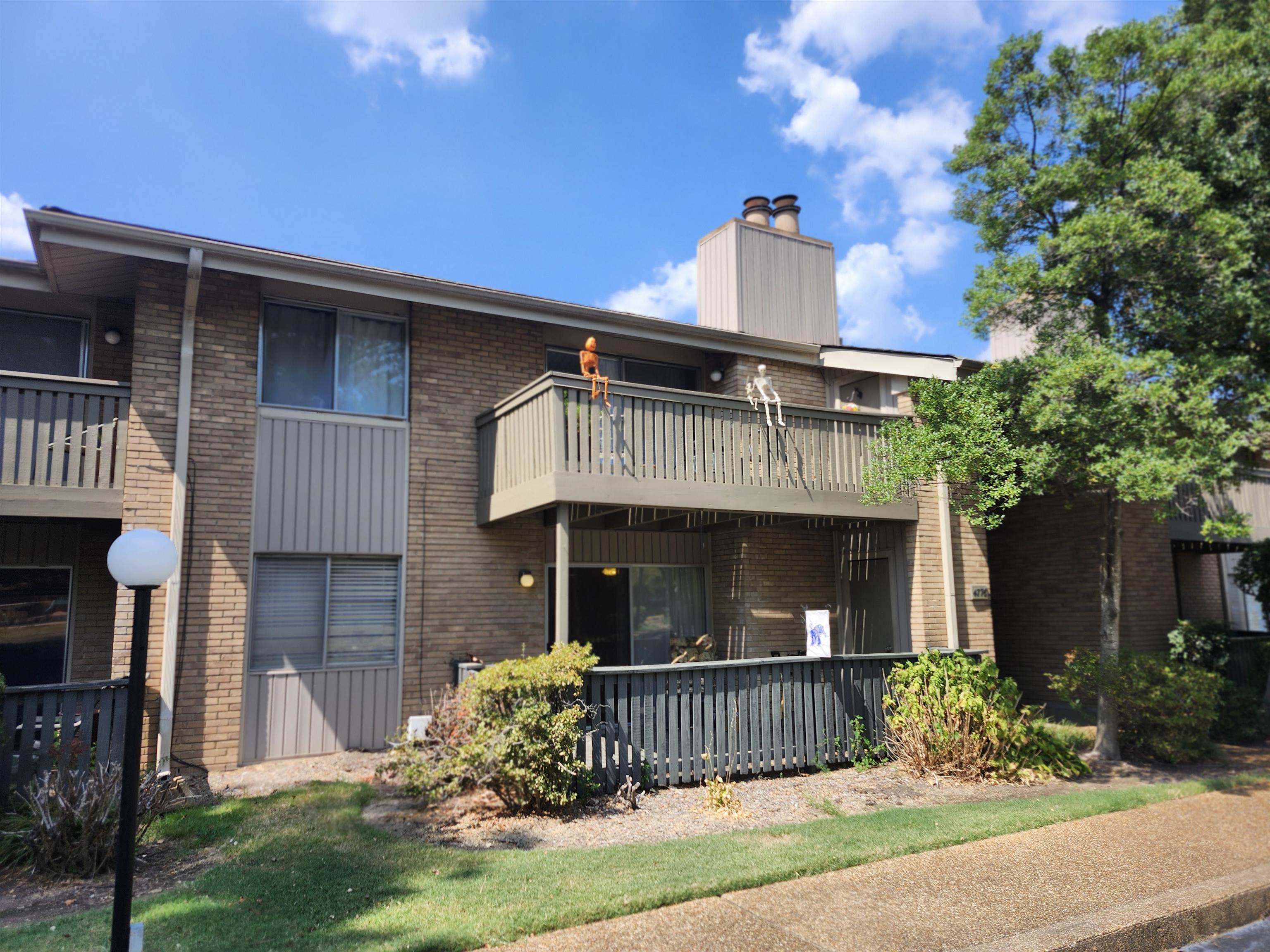 4776 Audubon View Circle, Unit 1 Memphis, TN 38117 - Photo 1 of 16 Rear view of house with brick siding, a chimney, and a balcony