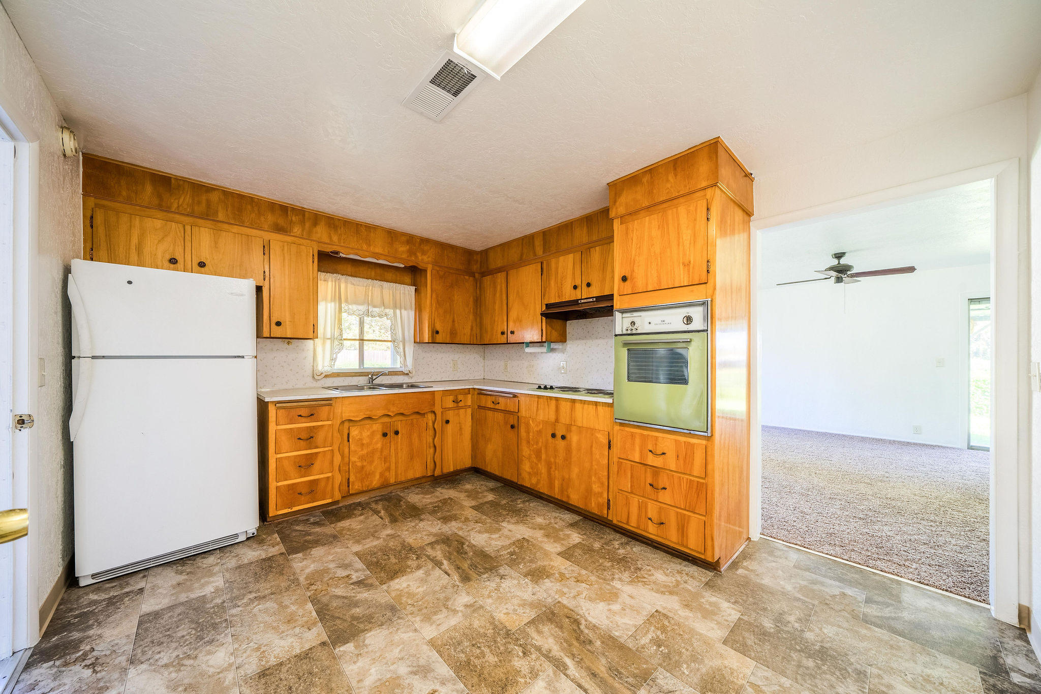 1138 Layton Road Redding, CA 96002 - Photo 7 of 22 a kitchen with stainless steel appliances a refrigerator and a stove