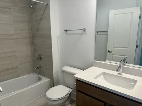 a bathroom with a sink a toilet and a bathtub