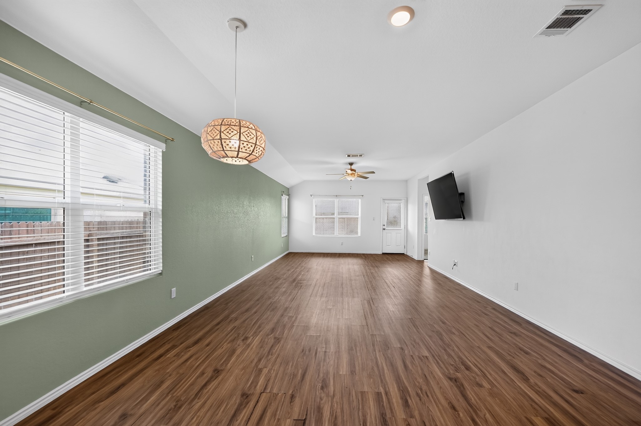 128 Konik Road Georgetown, TX 78626 - Photo 3 of 34 Rich hardwood-style flooring extends across this spacious living area with abundant natural light.