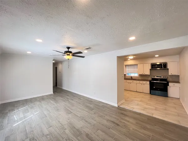 a view of a kitchen with a sink and a stove top oven