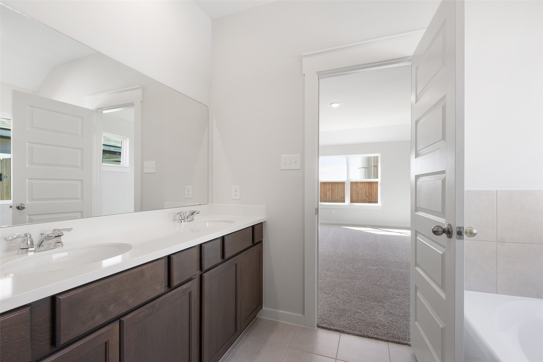 11811 Stratosphere Street Conroe, TX 77303 - Photo 13 of 13 a bathroom with a sink and a mirror