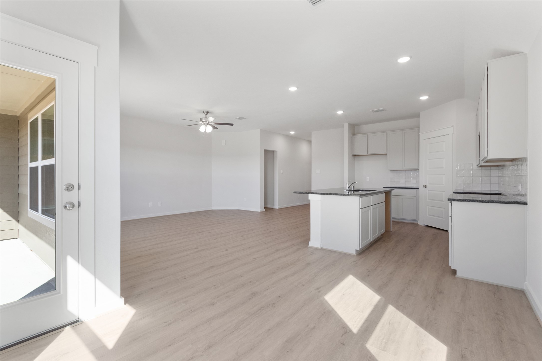 11811 Stratosphere Street Conroe, TX 77303 - Photo 7 of 13 a kitchen with a refrigerator and white cabinets