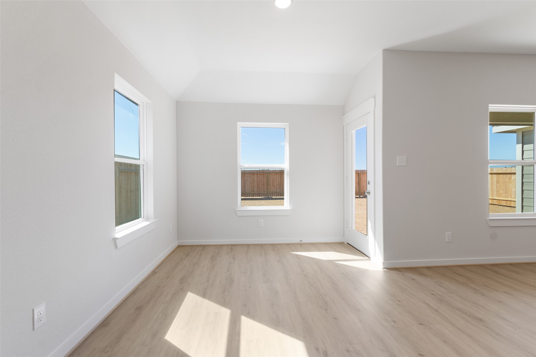 11811 Stratosphere Street Conroe, TX 77303 - Photo 8 of 13 an empty room with wooden floor and windows