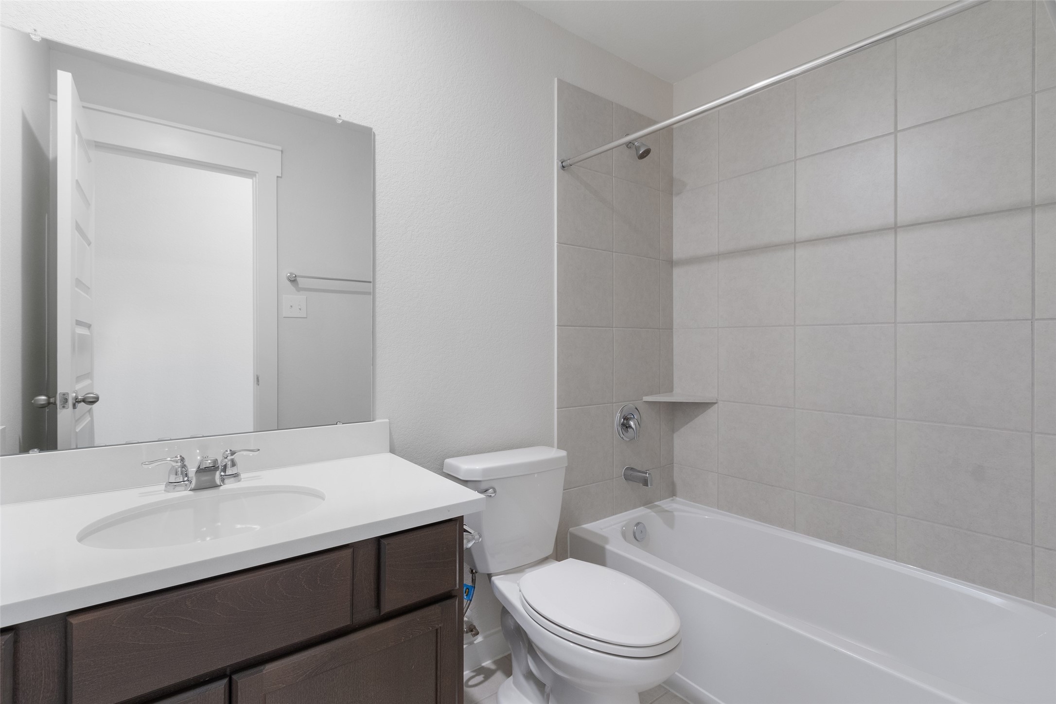 11811 Stratosphere Street Conroe, TX 77303 - Photo 9 of 13 a bathroom with a sink toilet vanity and shower