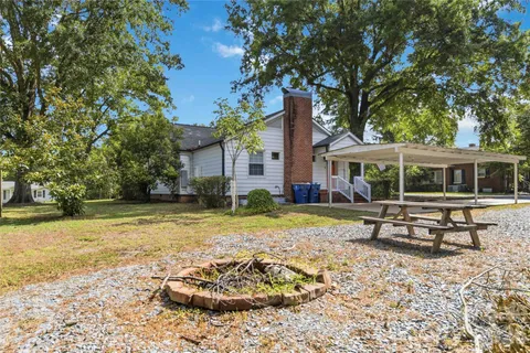 a view of a house with backyard porch and sitting area