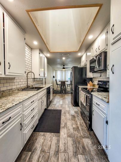 521 Sydnor Avenue Ridgecrest, CA 93555 - Photo 9 of 28 a large kitchen with stainless steel appliances lots of counter top space