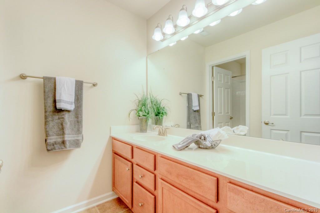 211 Chartwell Lane, Unit 211 Tega Cay, SC 29708 - Photo 16 of 19 a bathroom with a double vanity sink and a mirror