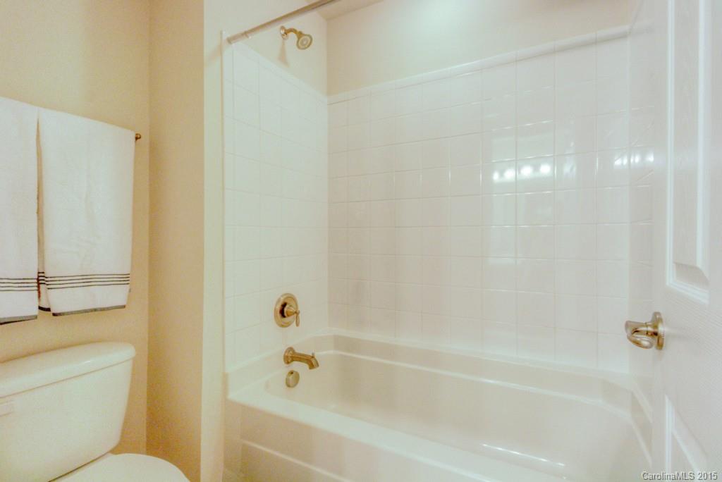 211 Chartwell Lane, Unit 211 Tega Cay, SC 29708 - Photo 17 of 19 a bathroom with a bathtub and a shower