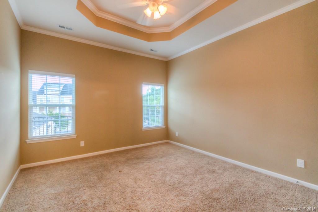 211 Chartwell Lane, Unit 211 Tega Cay, SC 29708 - Photo 10 of 19 an empty room with windows and closet