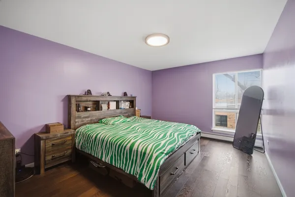 a bedroom with a bed and a chair