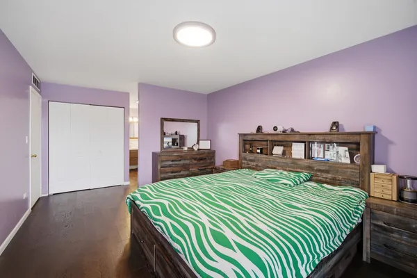 a bedroom with a bed and a view of kitchen