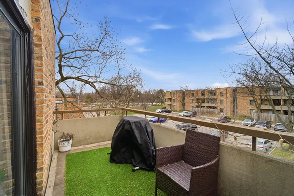a view of roof deck with couches and wooden fence