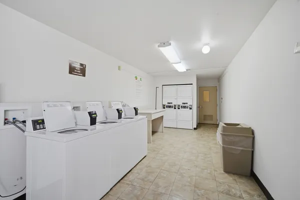 a view of kitchen with furniture and refrigerator
