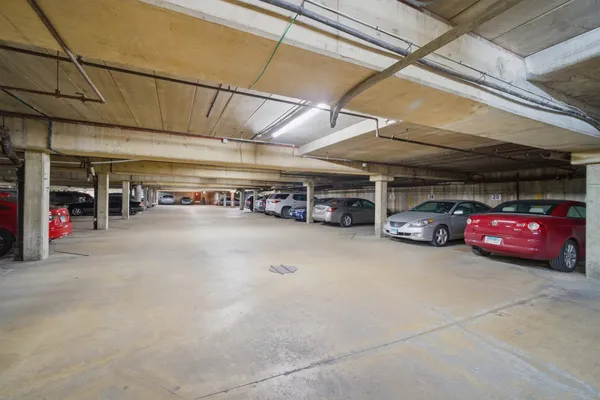 a view of parking garage with cars