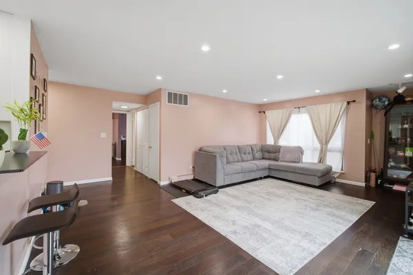 a living room with furniture window and wooden floor