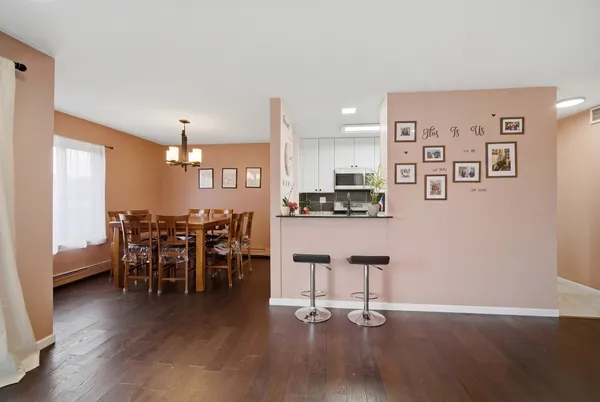 a view of a kitchen with dining space and wooden floor