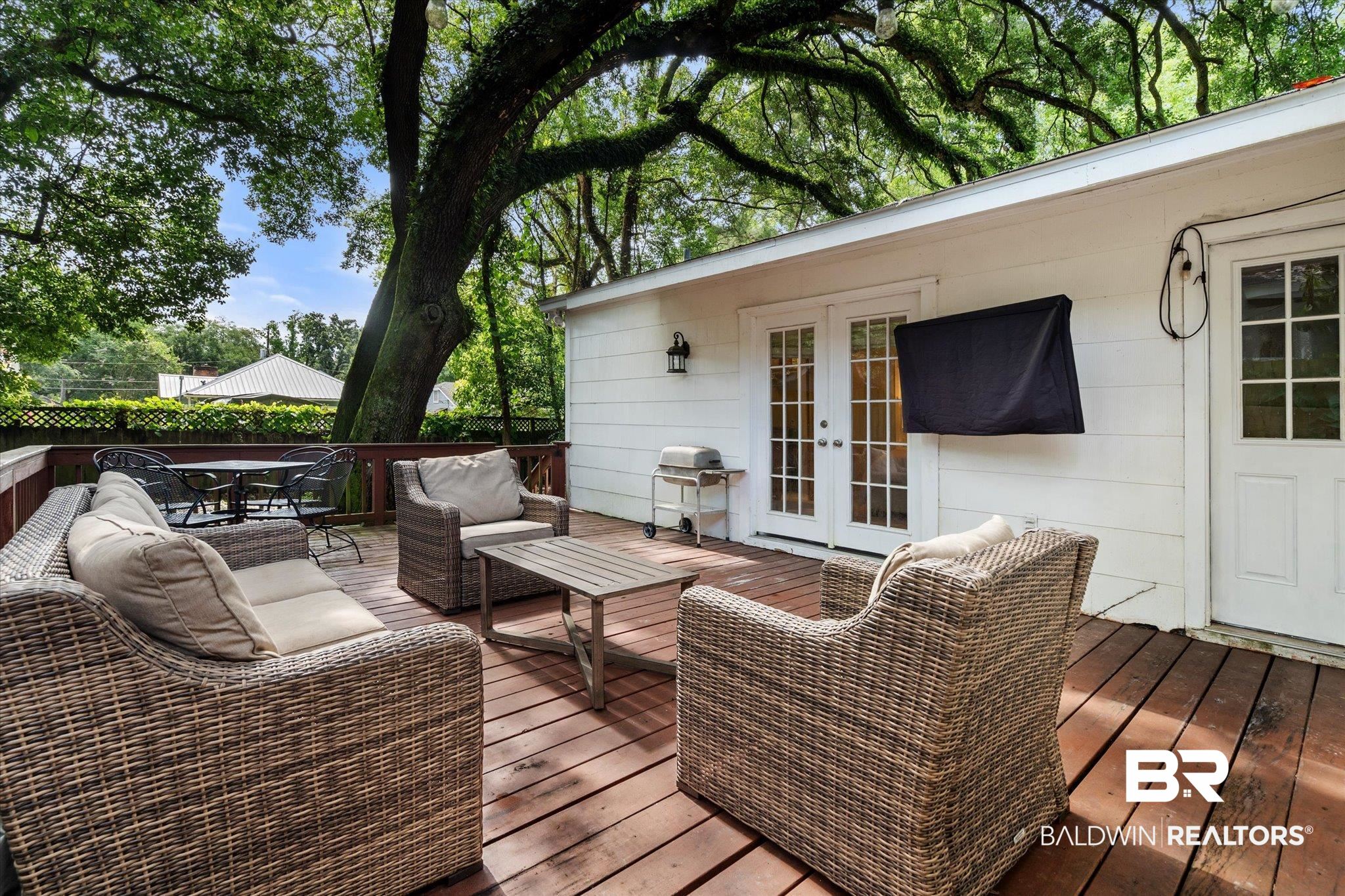 165 Crenshaw Street Mobile, AL 36606 - Photo 17 of 21 Wooden terrace with french doors, area for grilling, an outdoor hangout area, and outdoor dining area