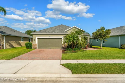 a kitchen with stainless steel appliances granite countertop a sink a stove a refrigerator and island with wooden floor