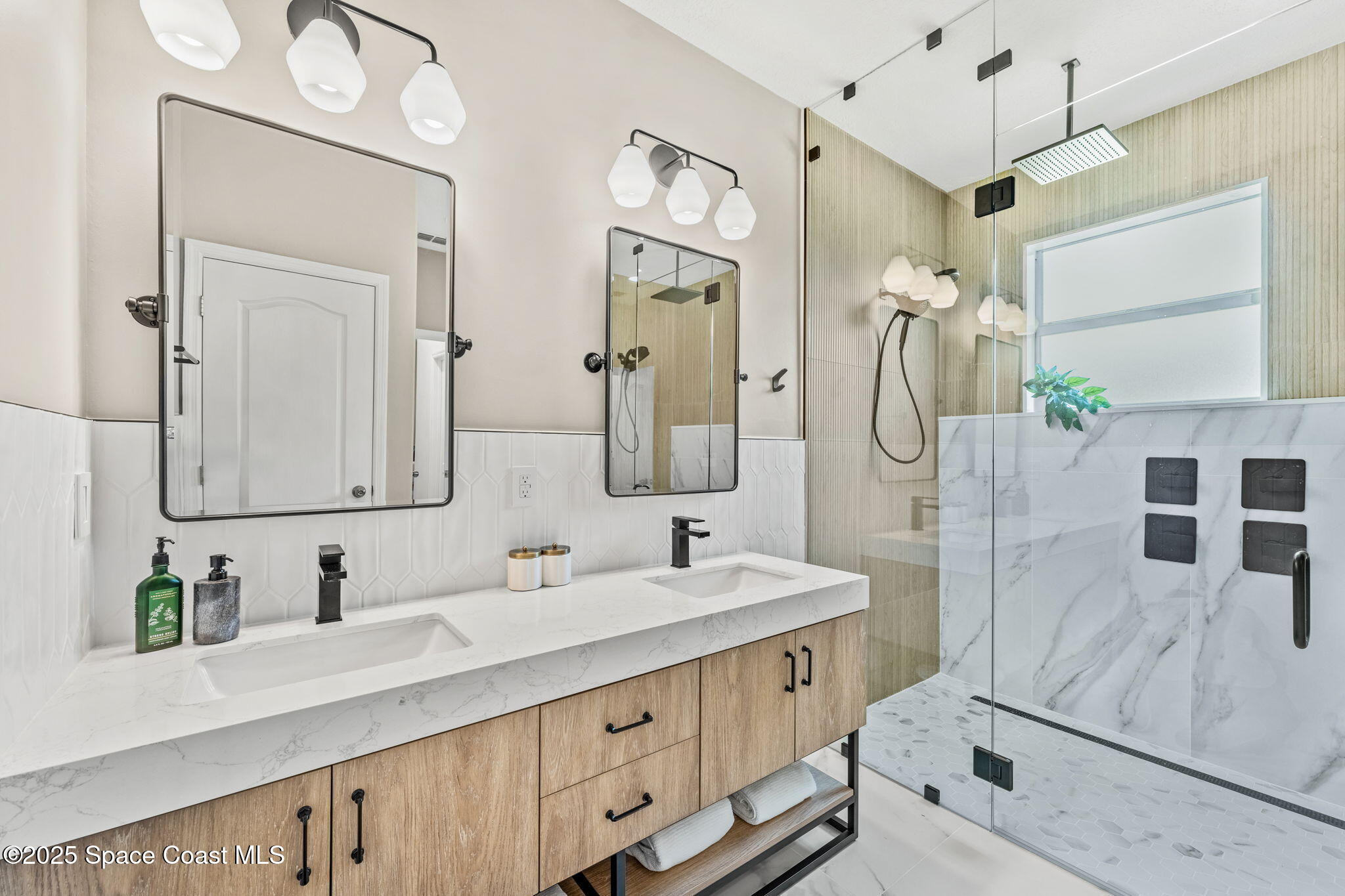 5824 Trieda Drive Melbourne, FL 32940 - Photo 13 of 45 a bathroom with double vanity sink and a mirror