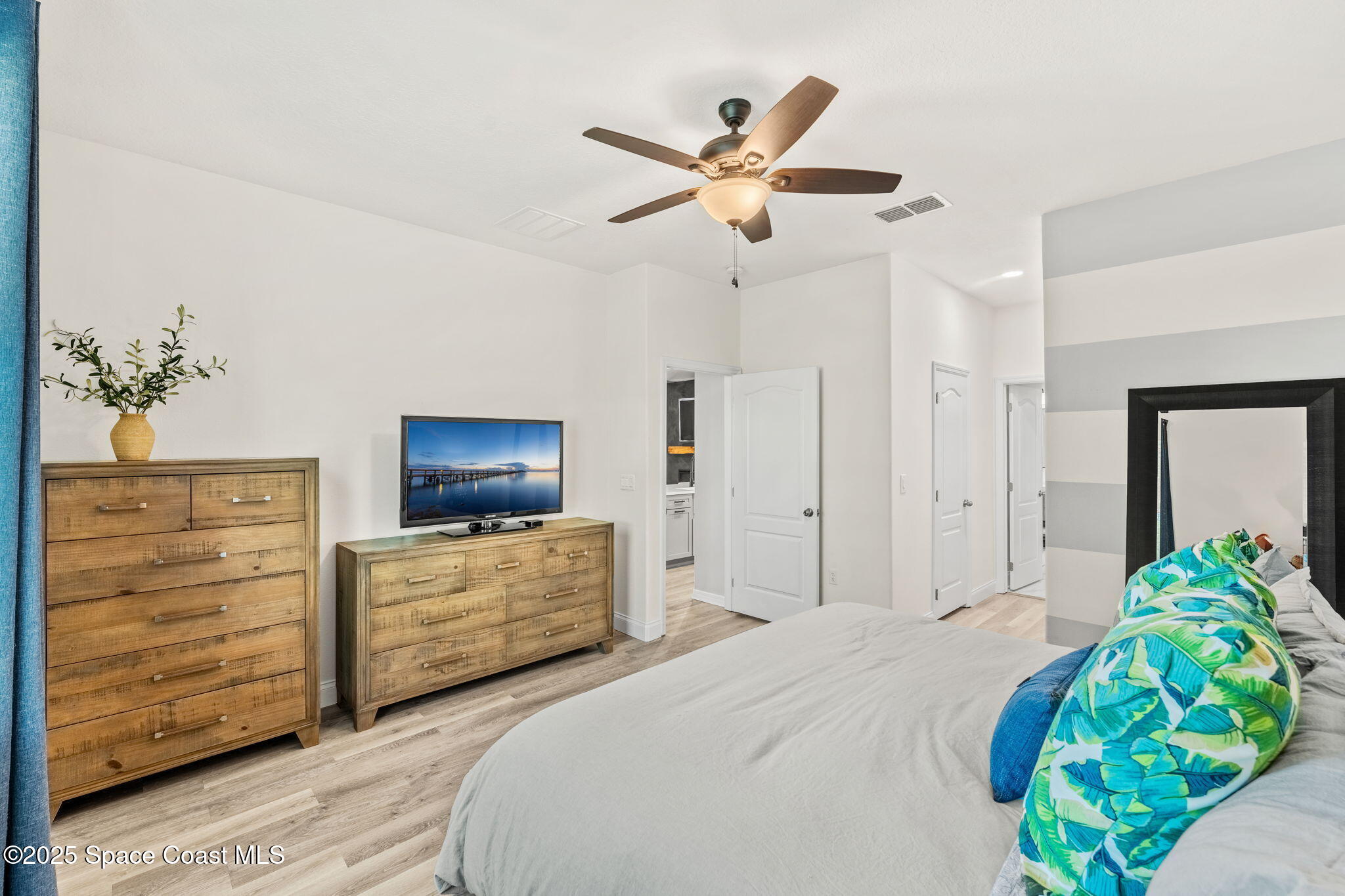 5824 Trieda Drive Melbourne, FL 32940 - Photo 15 of 45 a bedroom with a bed and a dresser