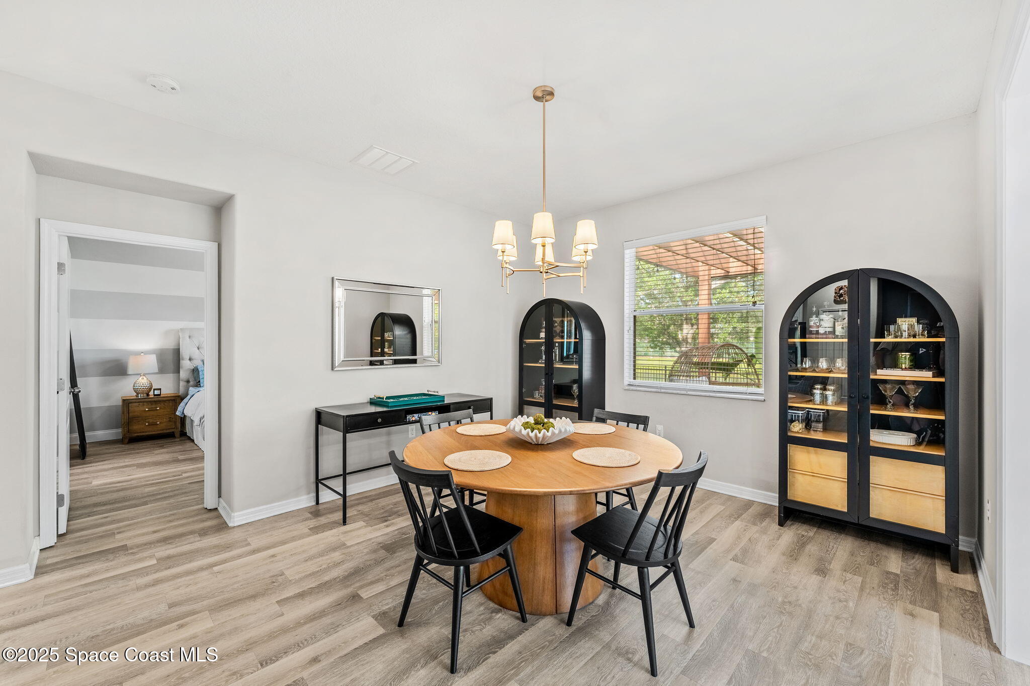 5824 Trieda Drive Melbourne, FL 32940 - Photo 19 of 45 a view of a dining room with furniture window and wooden floor