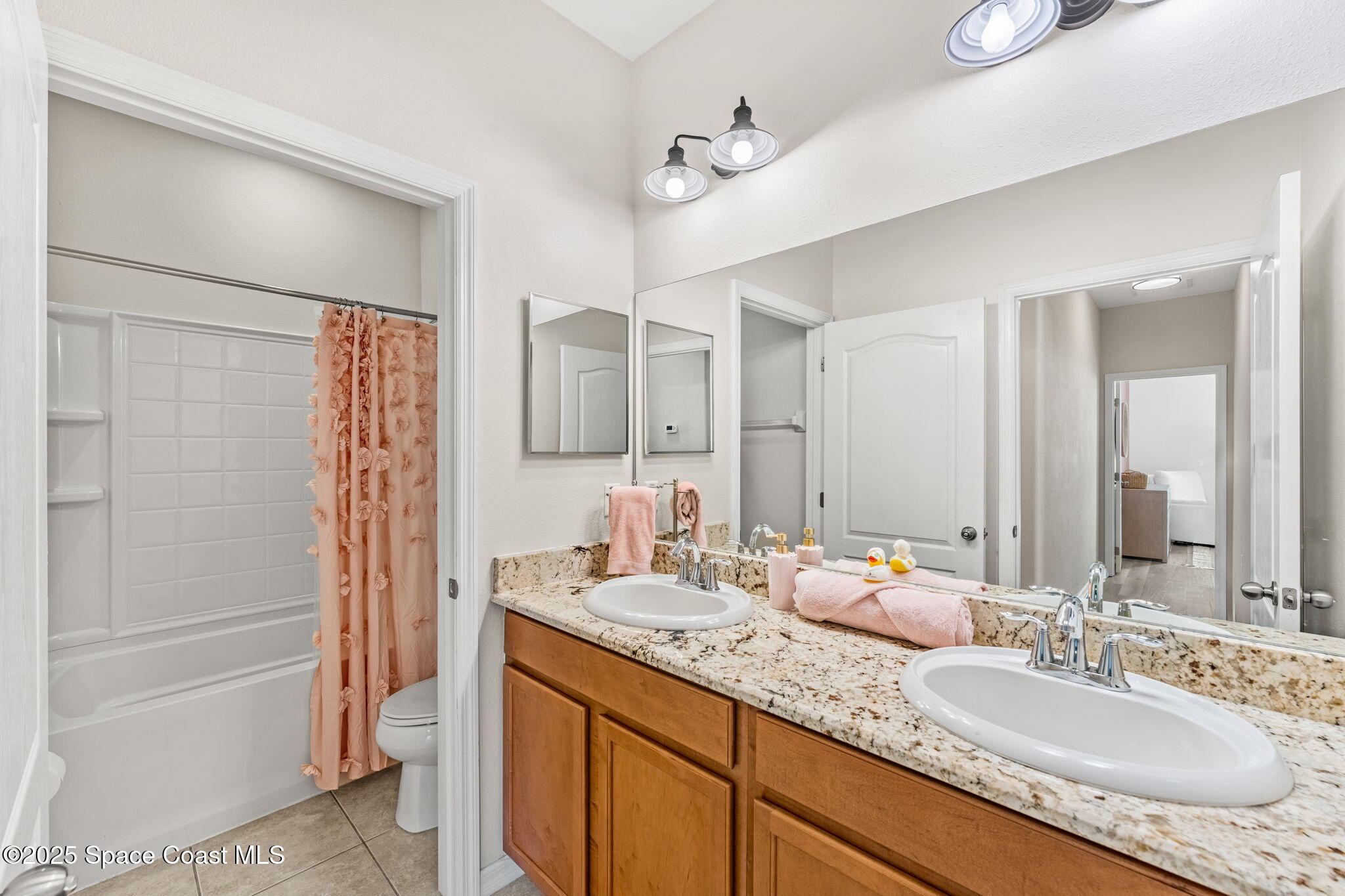 5824 Trieda Drive Melbourne, FL 32940 - Photo 22 of 45 a bathroom with a granite countertop sink and a mirror