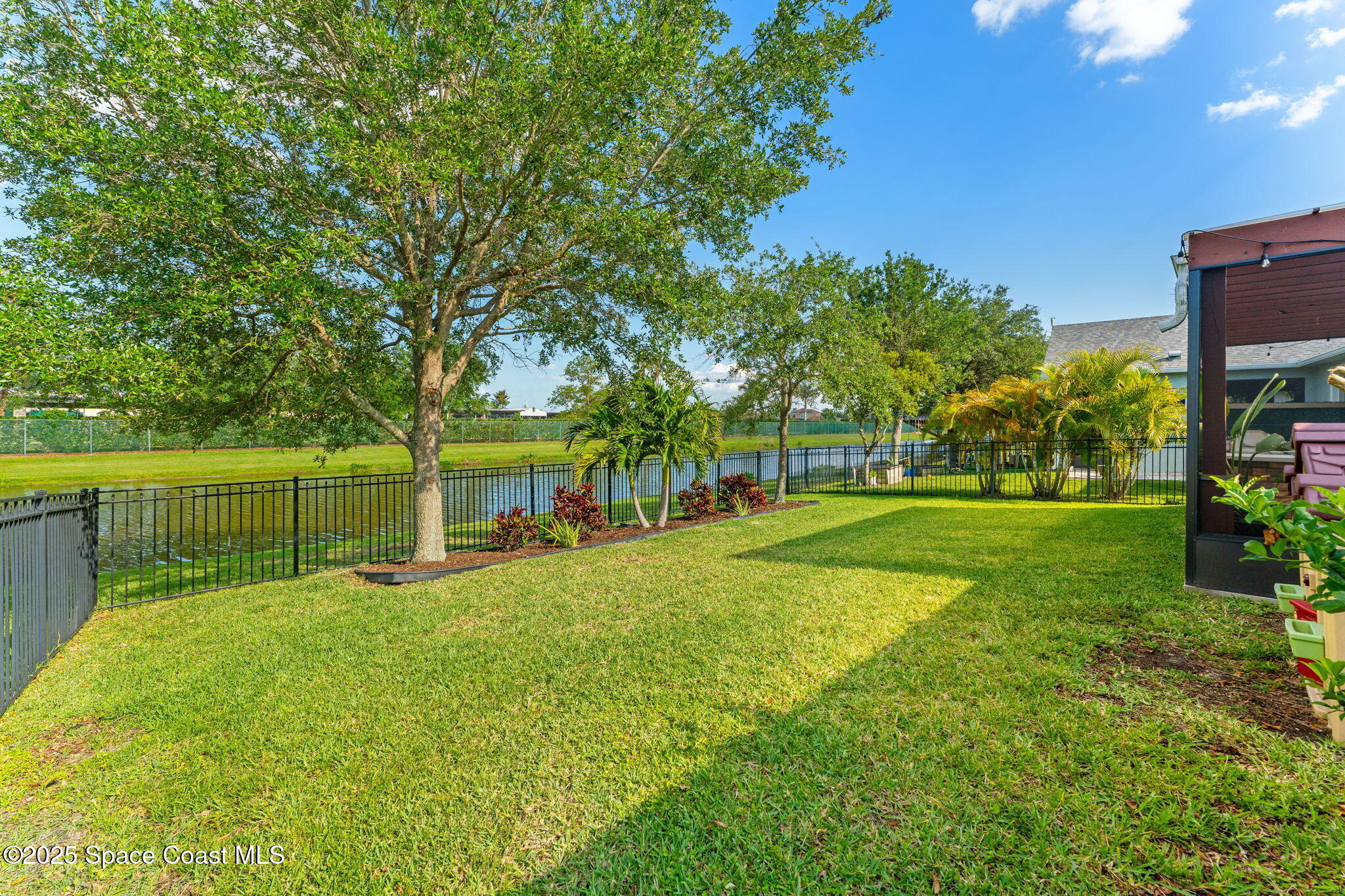 5824 Trieda Drive Melbourne, FL 32940 - Photo 29 of 45 a view of a house with a big yard and potted plants