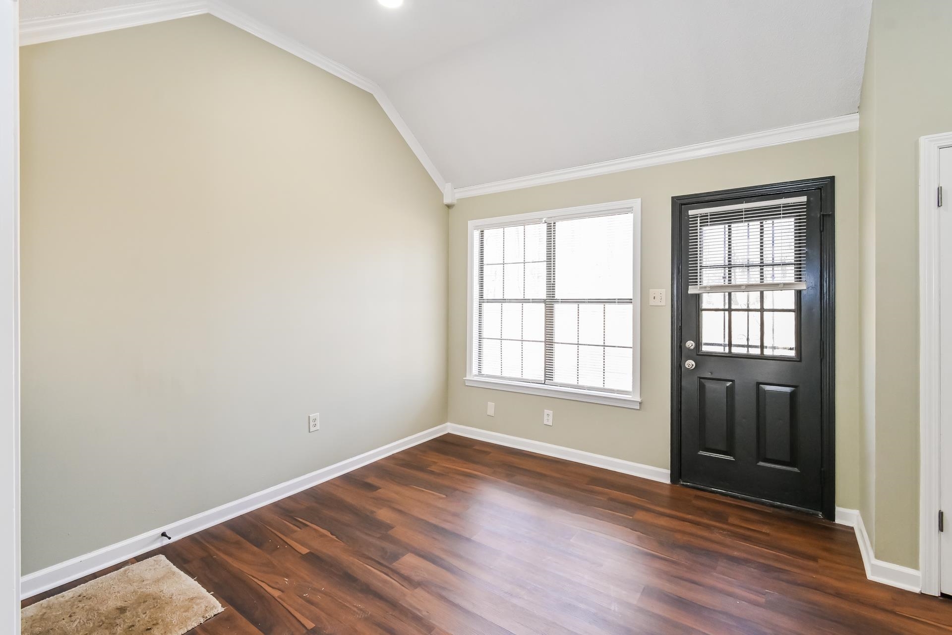 5833 South Newberry Lane Memphis, TN 38115 - Photo 5 of 16 an empty room with wooden floor and windows