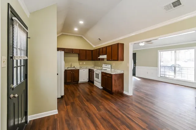 a kitchen with a refrigerator and a stove top oven