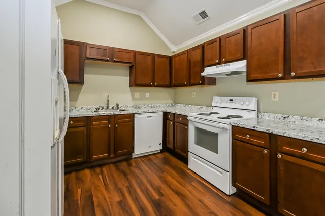 a kitchen with a stove top oven sink and cabinets