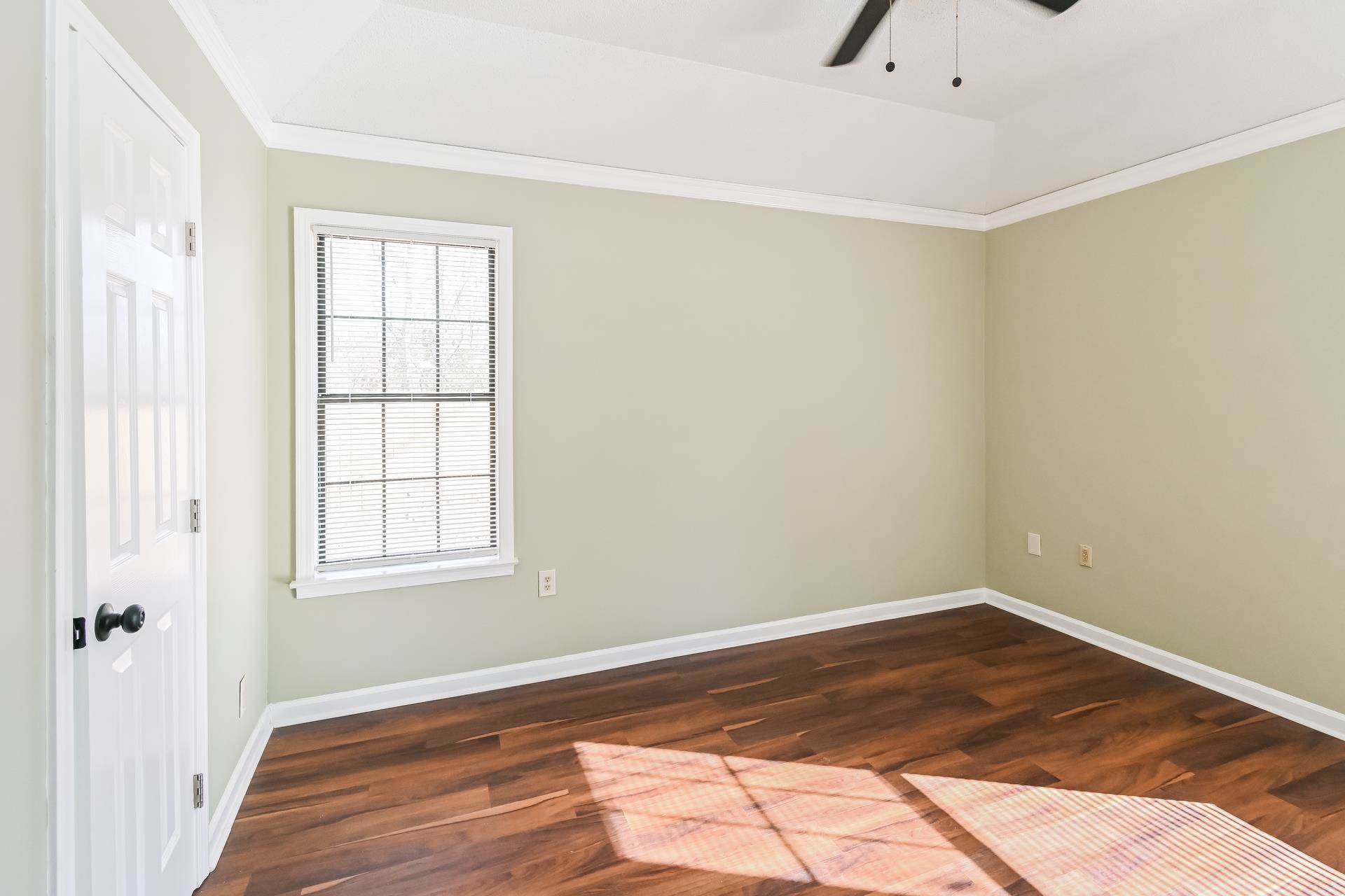 5833 South Newberry Lane Memphis, TN 38115 - Photo 10 of 16 an empty room with wooden floor and windows