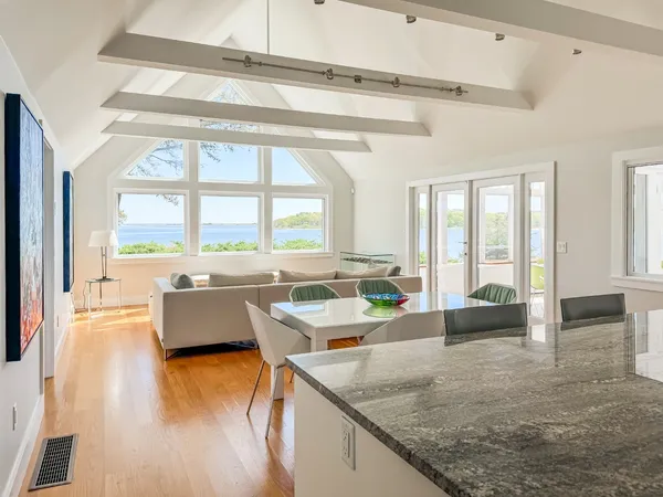 a large white kitchen with a large window