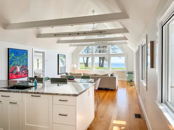 a view of living room with granite countertop furniture and a flat screen tv