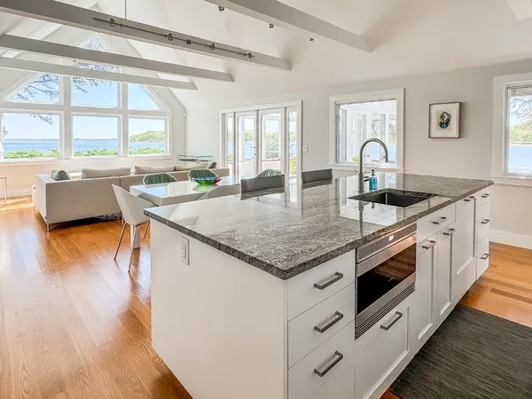 a kitchen with stainless steel appliances granite countertop a stove and a wooden floors