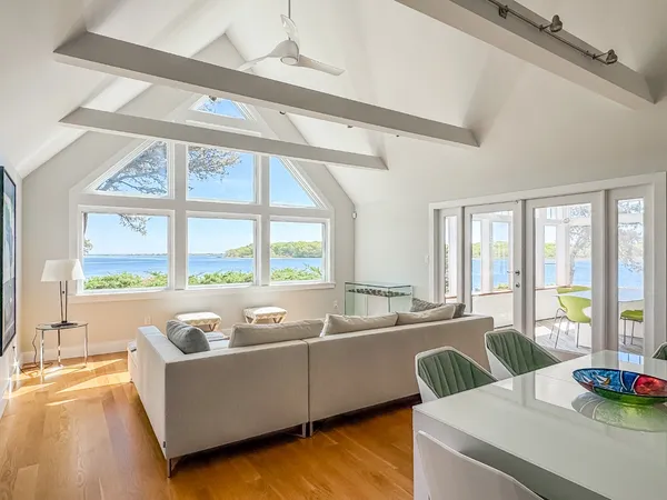 a living room with furniture and floor to ceiling windows