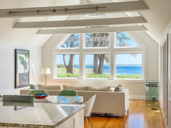 a living room with a window and a table