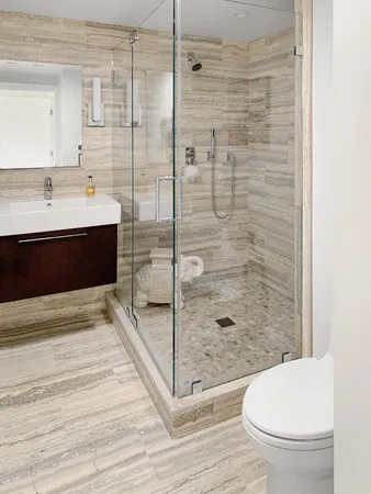 a bathroom with a sink a toilet and shower