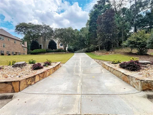 a view of a swimming pool with a yard