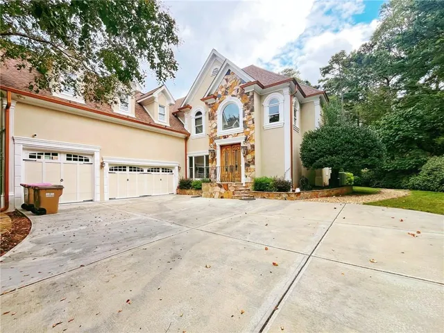 a view of staircase with railing and white walls
