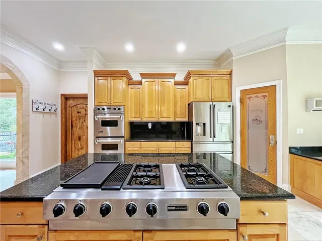 a view of an empty room with a fireplace and a window