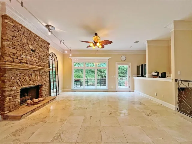 a view of a big room with windows and chandelier fan