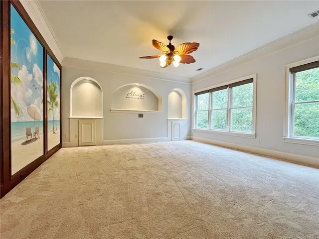 a bathroom with a granite countertop sink a toilet a mirror and shower